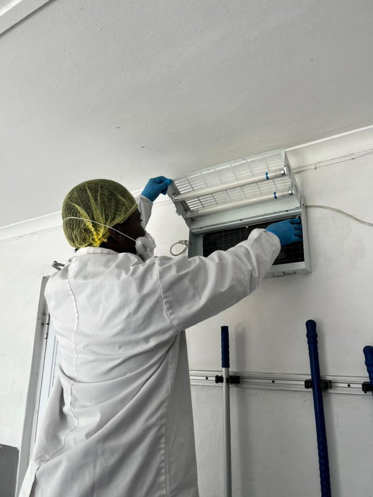 ASC pest control operator servicing an insect light trap at a Johannesburg food facility