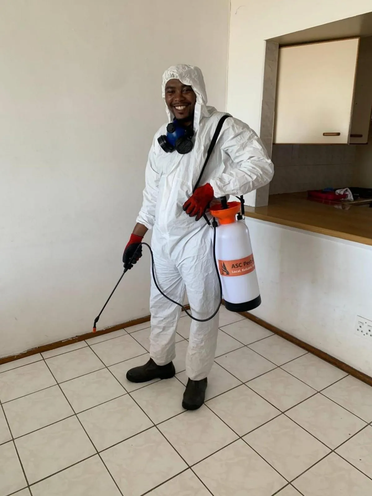 ASC Pest Control technician applying a targeted, registered residential treatment along a skirting board in a Gqeberha home